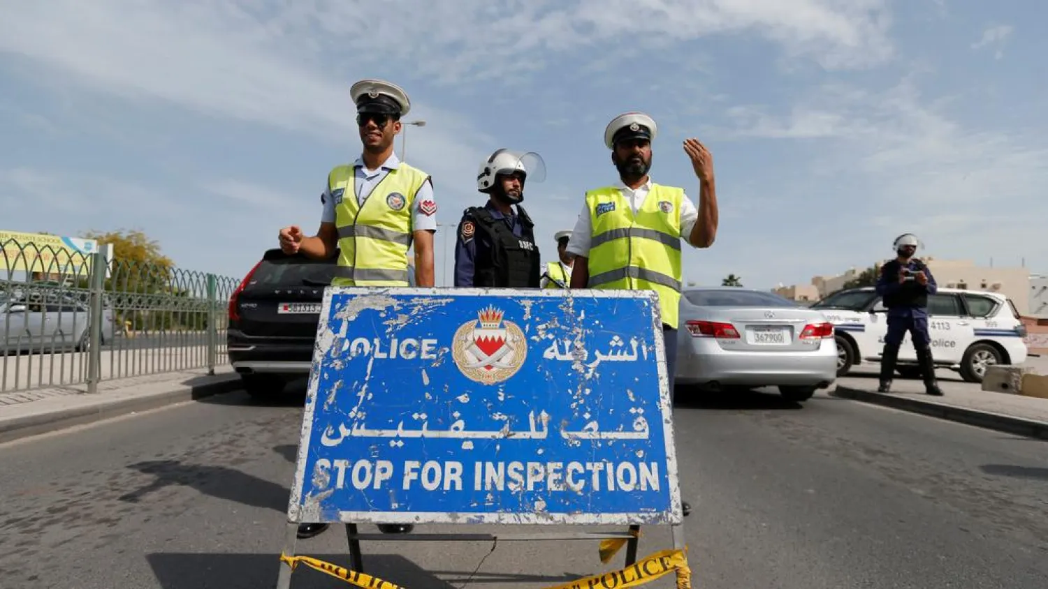 Police and security officials stand guard at a checkpoint on a highway in Sanabis west of Manama, Bahrain on February 9, 2017. (Reuters)