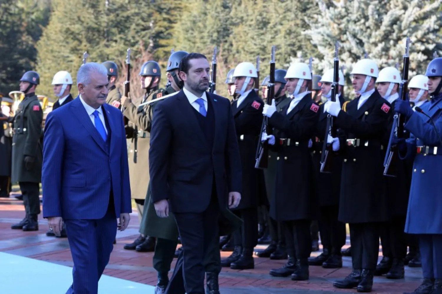 Lebanese Prime Minister Saad Hariri (R) and Turkish Prime Minister Binali Yildirim (L) review an honor guard during an official ceremony at Cankaya Palace in Ankara on January 31, 2018. ADEM ALTAN / AFP