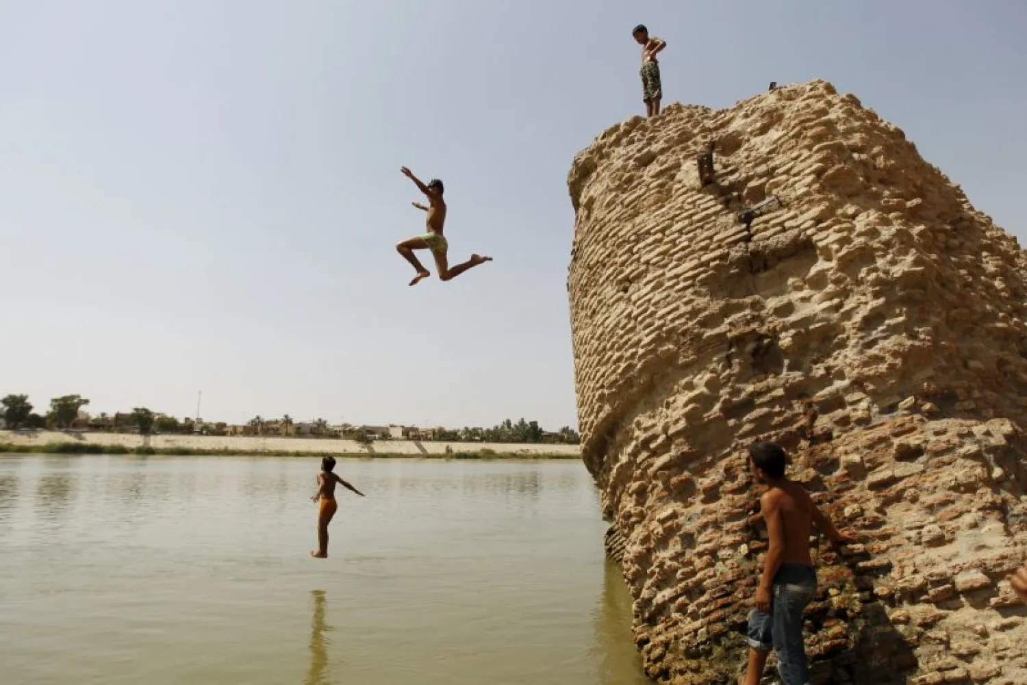 File photo: People dive into the Tigris river to cool off in northern Baghdad (Reuters/Ahmed Saad)