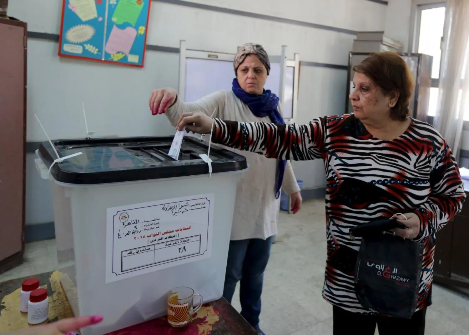 Women cast their votes at a school used as a polling station during the second phase of the parliamentary election runoff at the Shubra area of Cairo, Egypt, December 1, 2015. REUTERS/Mohamed Abd El Ghany