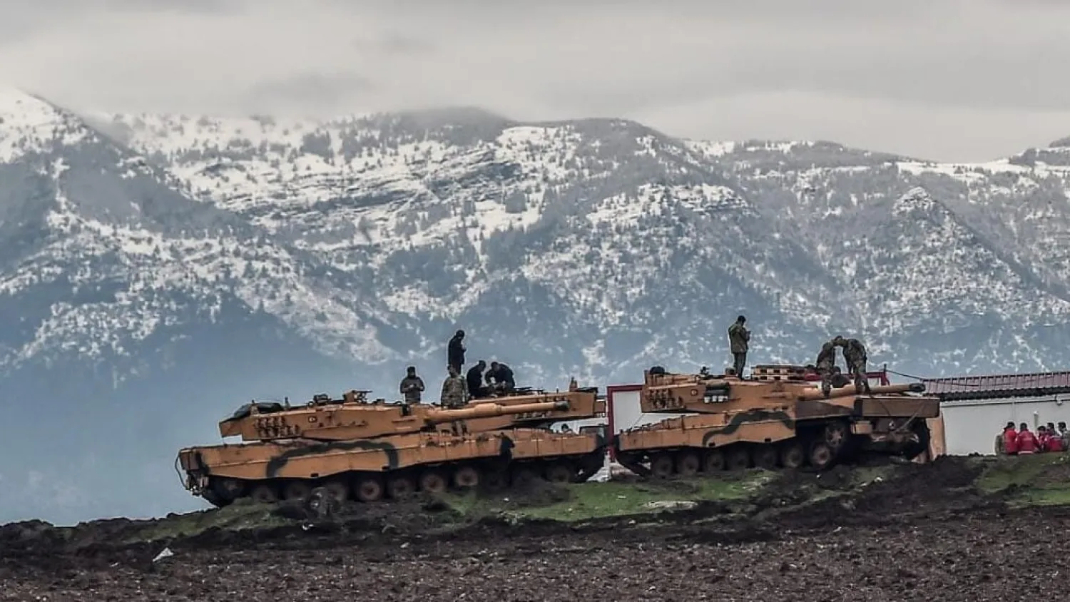 Turkish tanks are parked near the Syrian border at Hassa, in Turkey’s Hatay province, as part of the operation "Olive Branch", on 24 January 2018. AFP/Ozan Kose
