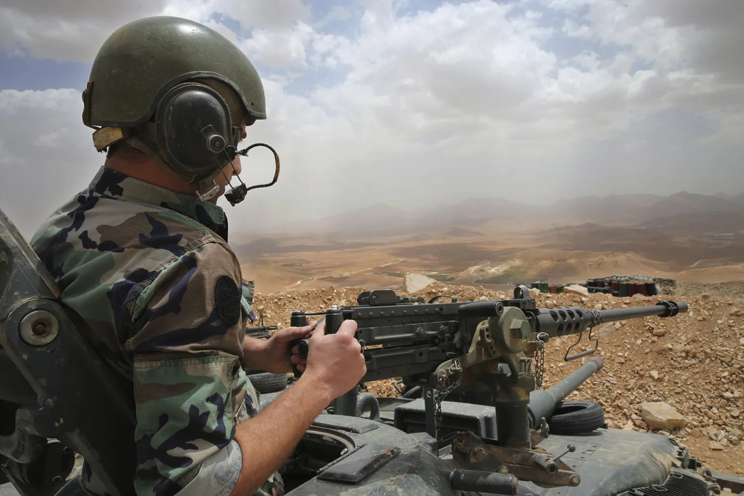 In this Sunday June 19, 2016 file photo, a Lebanese army soldiers sits on a tank at one of the frontline hills overlooking areas controlled by ISIS at the edge of the town of Arsal, on the Syrian border, in northeast Lebanon. (Hussein Malla/AP)