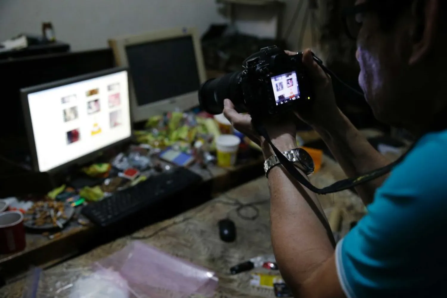 A Filipino police investigator takes a picture of the computer of a suspected child exploitation operation. (AP: Aaron Favila)