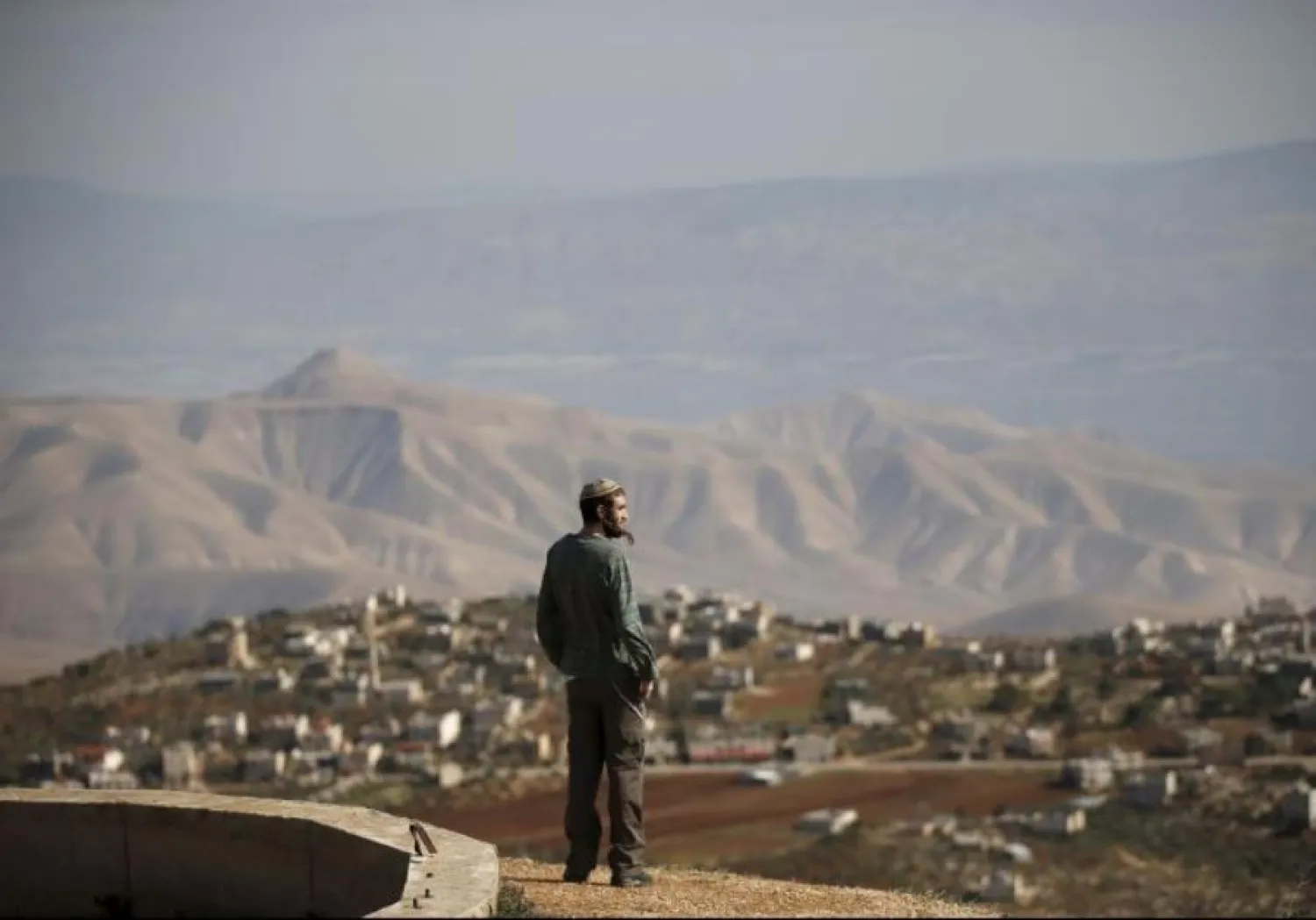 Jewish settler Refael Morris stands at an observation point overlooking the West Bank village of Duma, near Yishuv Hadaat, an unauthorized Jewish settler outpost. (photo credit: REUTERS)
