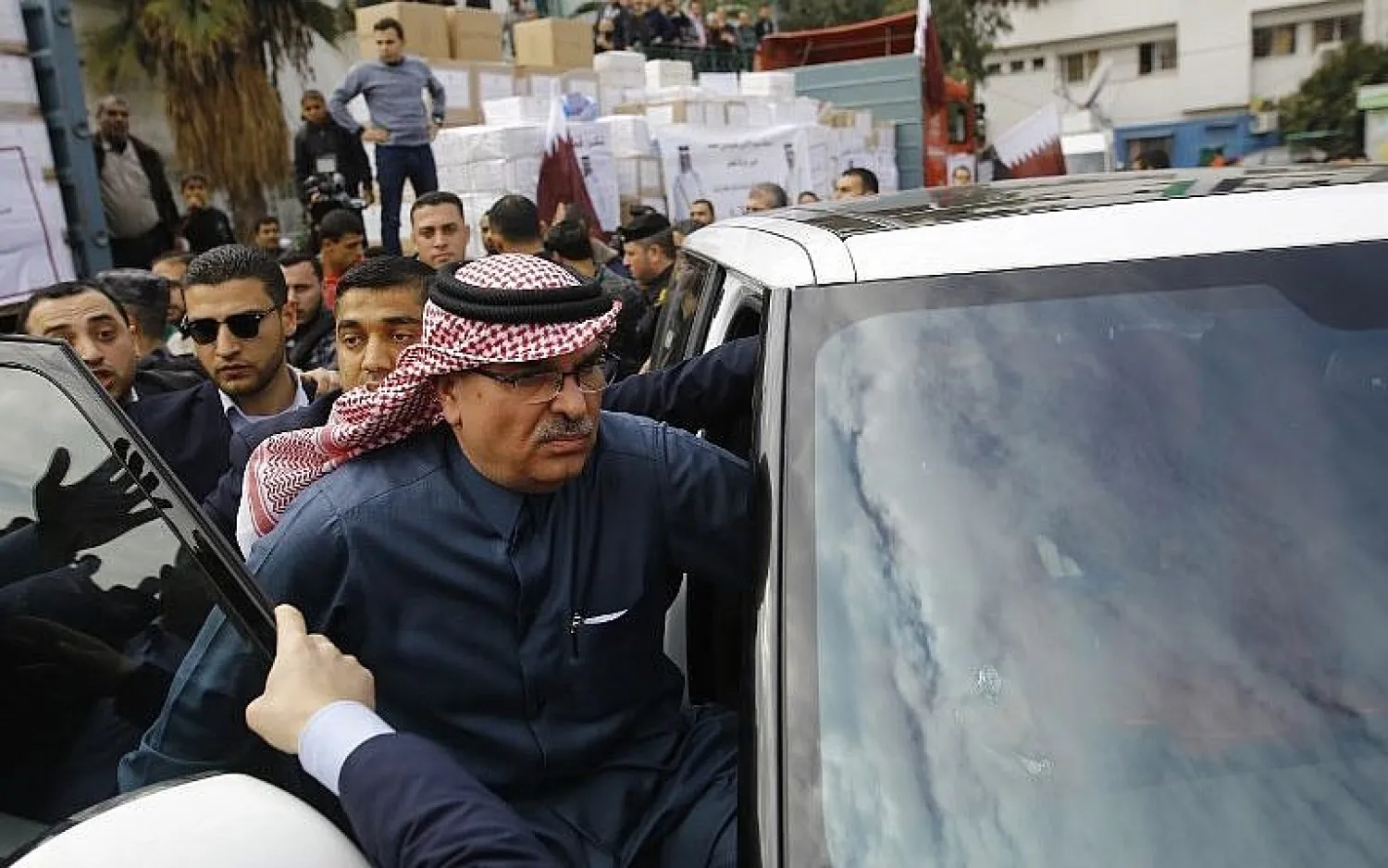 Qatari envoy Mohammed Al-Emadi (C) leaves a press conference at the Dar al-Shifa hospital in Gaza City, on February 19, 2018. Hospital workers tried to approach Al-Emadi as he left, but were pushed back by Hamas policemen. (AFP Photo/Mohammed Abed)