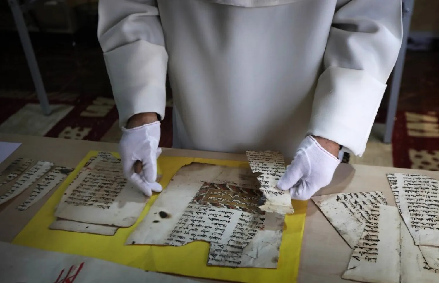 Father Najeeb Michaeel works on an old manuscript at the Oriental Manuscript Digitisation Center (CNDO) in Arbil. SAFIN HAMED / AFP