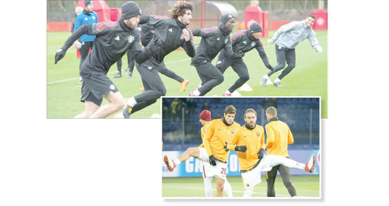 دي روسي قائد روما مع زميله فازيو في التدريبات (رويترز) - لاعبو مانشستر يونايتد خلال التدريبات أمس  استعدادا لمواجهة إشبيلية (إ.ب.أ)