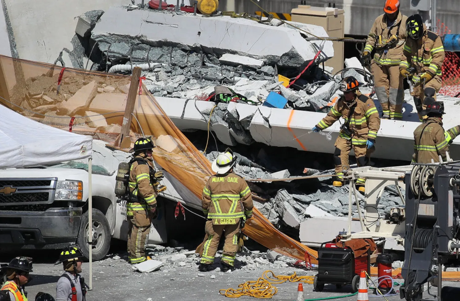 Rescuers search through the rubble of the FIU pedestrian bridge collapse on Thursday, March 15, 2018, at SW 109th Avenue and 8th Street in Miami. (Michael Laughlin/Sun Sentinel/TNS via Getty Images)