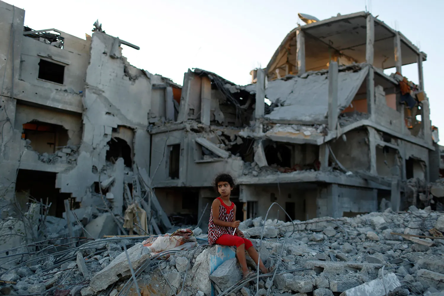  A girl sits on the ruins of her family home in the Beit Hanoun neighborhood of Gaza City (Siegfried Modola/Reuters)