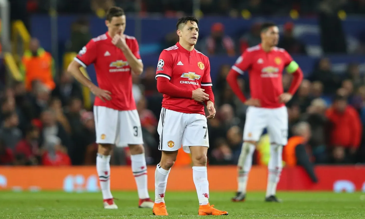Alexis Sánchez, Nemanja Matic and Chris Smalling look dismayed after Manchester United’s Champions League defeat by Sevilla at Old Trafford. Photograph: Alex Livesey/Uefa via Getty Images