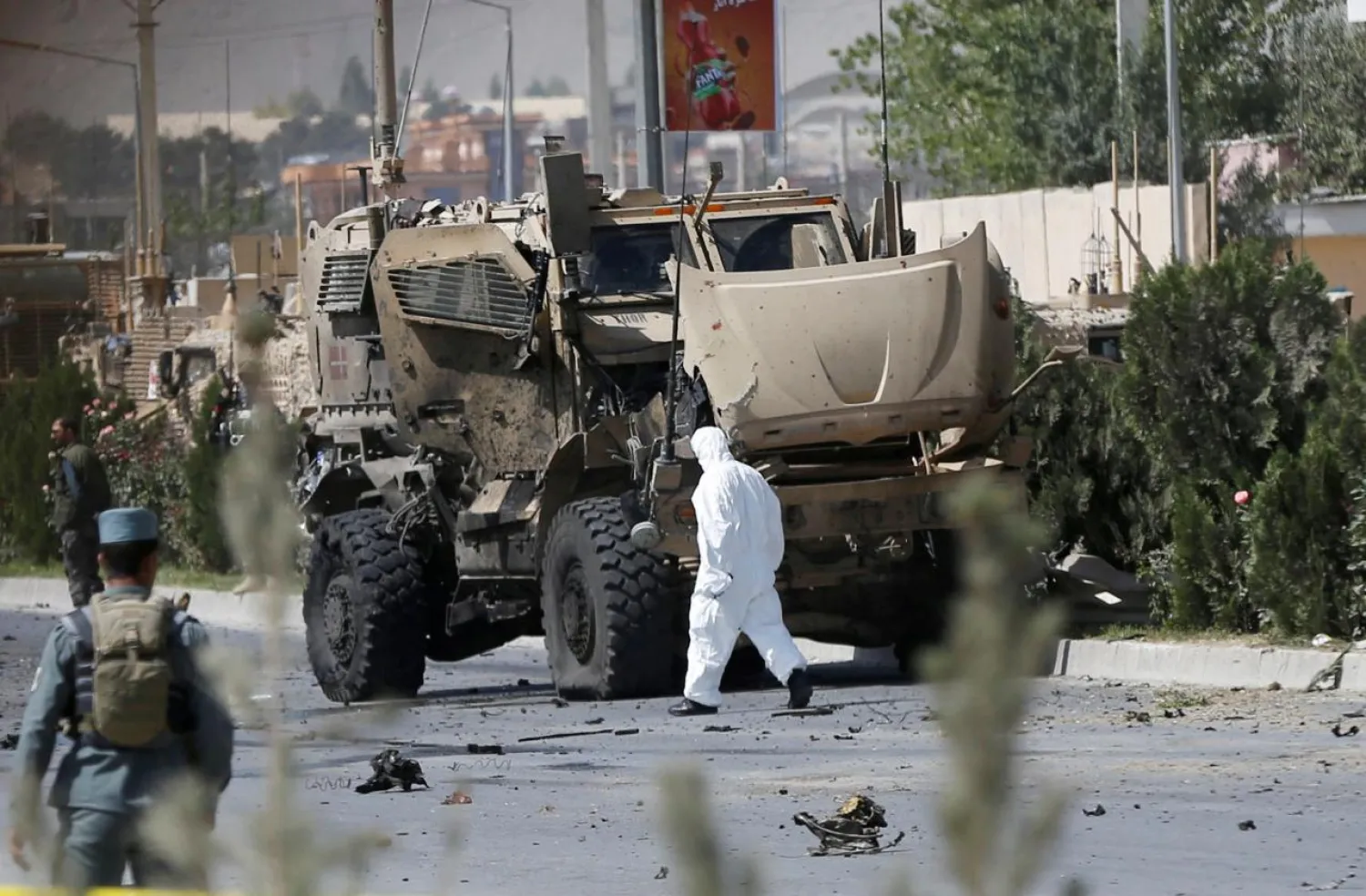 An Afghan official investigates a damaged Danish convoy at the site of a car bomb attack in Kabul, Afghanistan September 24, 2017. REUTERS/Omar Sobhani