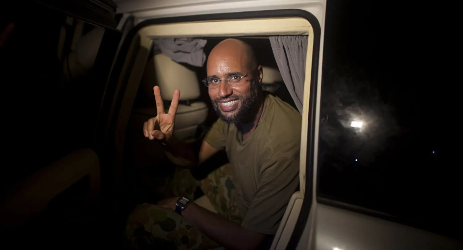 Moammar Gadhafi's son, Saif al-Islam, makes the victory sign as he appears at the Rixos Hotel in Tripoli, Libya (AP Photo/ Dario Lopez-Mills)