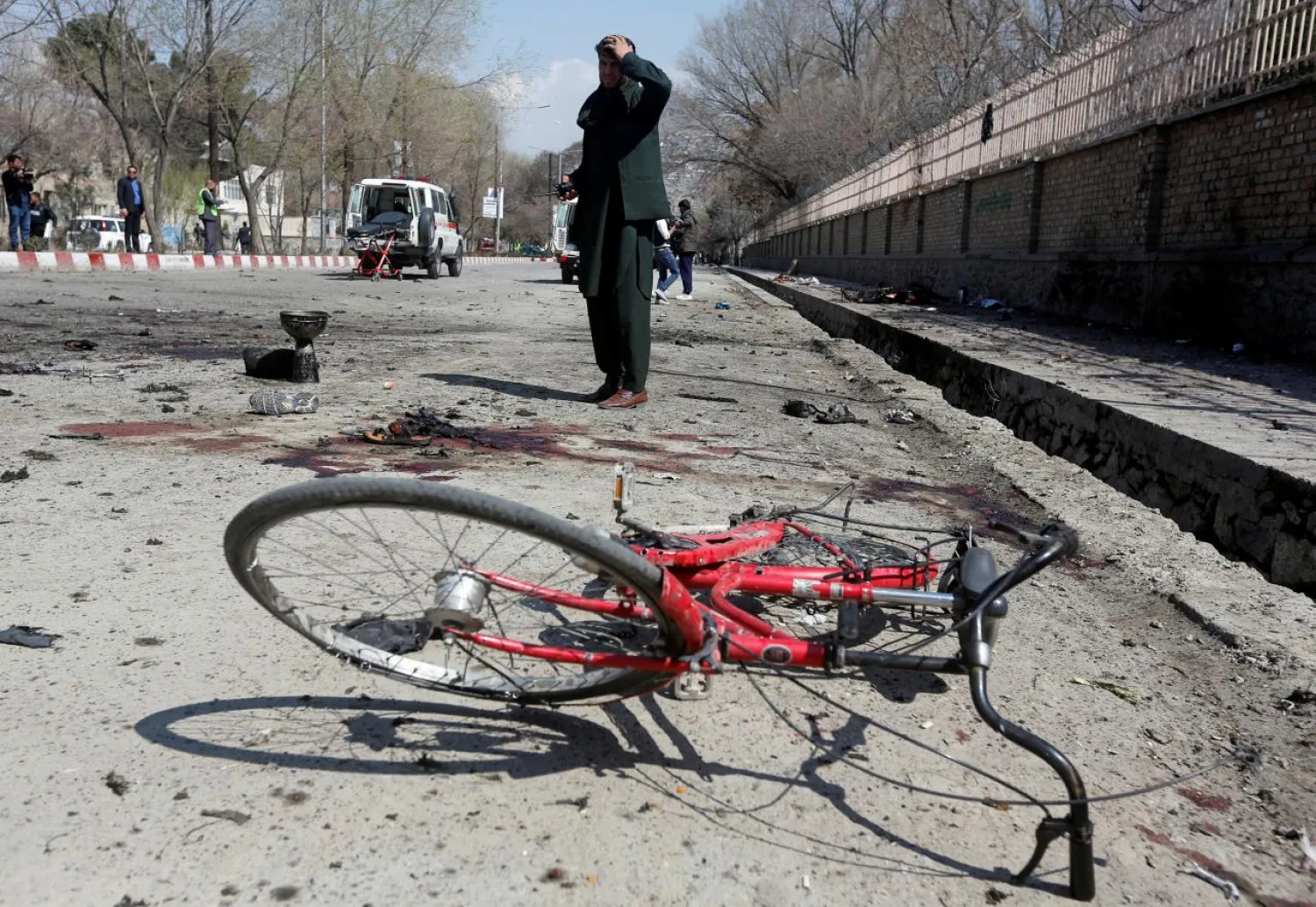 An Afghan man inspects the site of a suicide attack in Kabul, Afghanistan March 21, 2018. REUTERS/Omar Sobhani