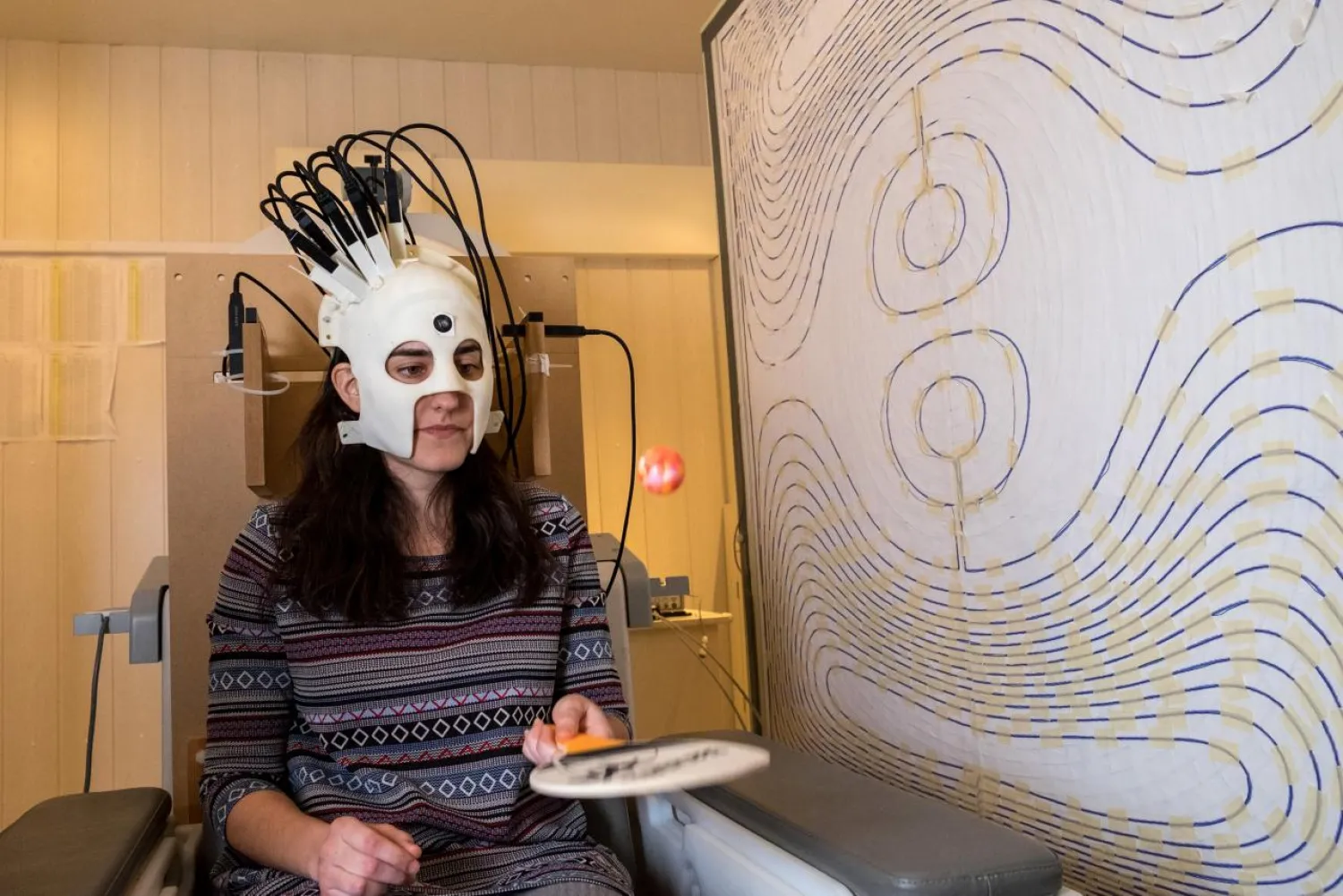 A woman is seen wearing a lightweight and highly sensitive brain imaging device in this undated handout photograph supplied by Wellcome and released in London, Britain March 22, 2018. Wellcome/Handout via REUTERS