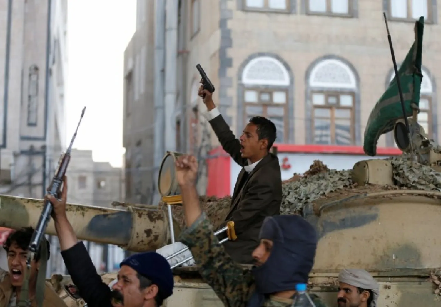 Houthi militants react as they gather next to a tank after the death of Yemen's former president Ali Abdullah Saleh, in Sanaa, Yemen on 4 December 2017 Reuters
