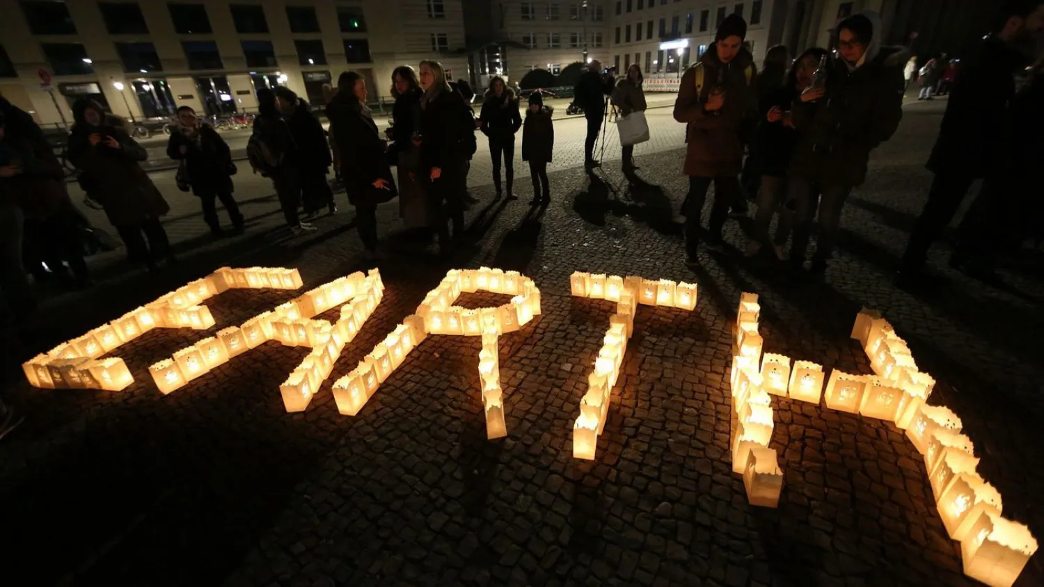 Participants take part in Earth Hour 2018 in front of Berlin's Brandenburg Gate on Saturday. Organizers say Earth Hour has participants in 154 countries and territories and over 5,000 cities agreeing to switch off their lights for one hour. (Adam Berry / Getty Images)
