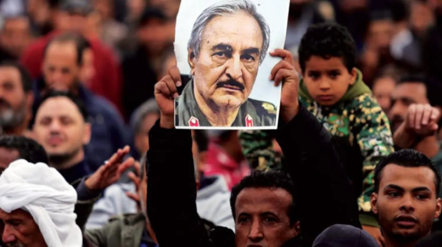 Libyan National Army supporters raise Marshal Khalifa Haftar's image in Benghazi (Reuters)