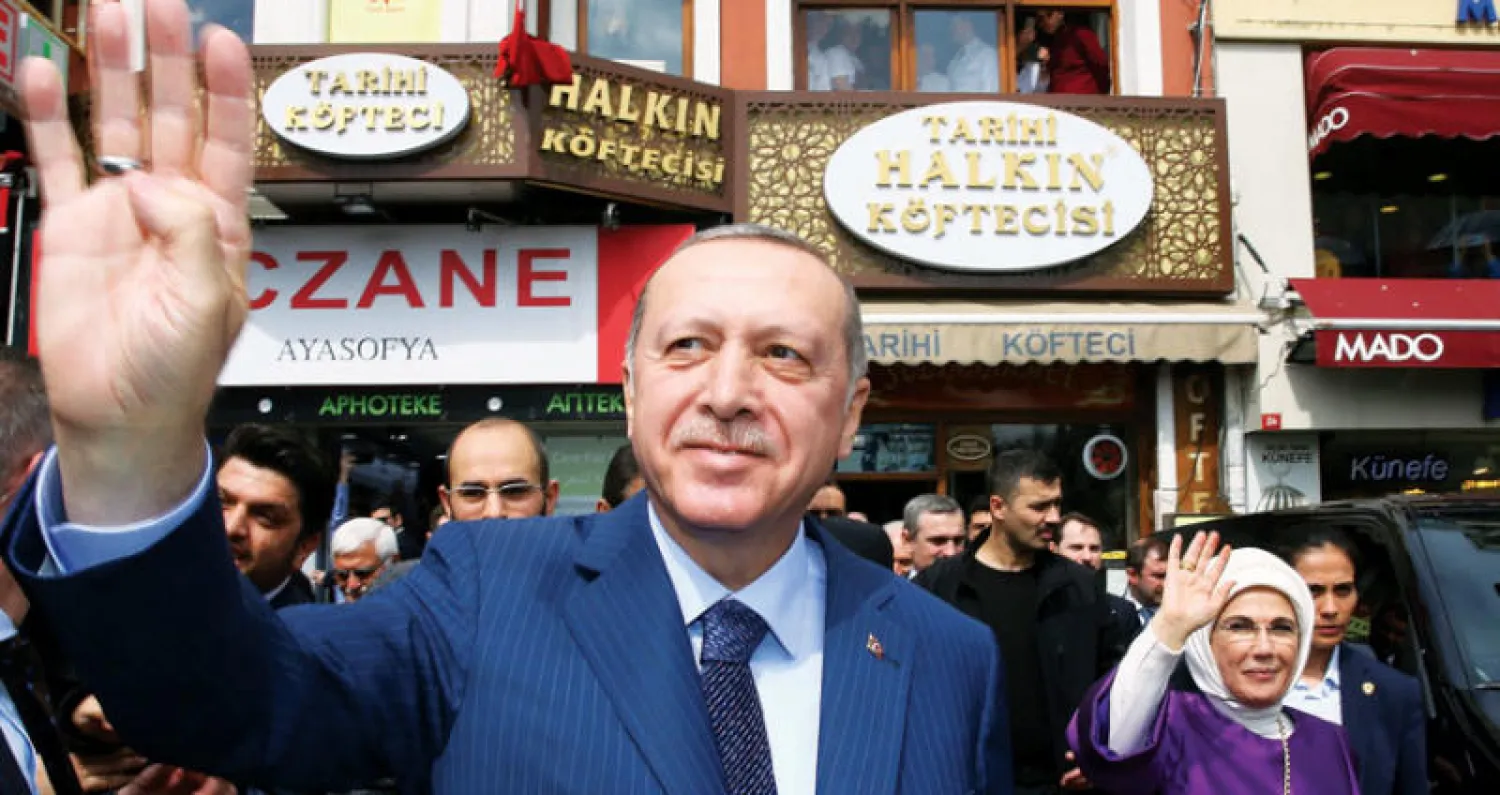إردوغان وزوجته يحيِّيان أنصارهما بعد زيارة مطعم في إسطنبول السبت (أ.ف.ب)