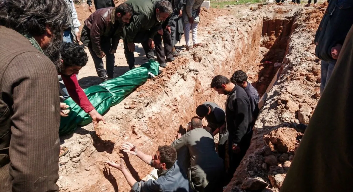 Syrians dig a grave to bury the bodies of victims of a gas attack in Khan Sheikhun on April 5. (AFP)