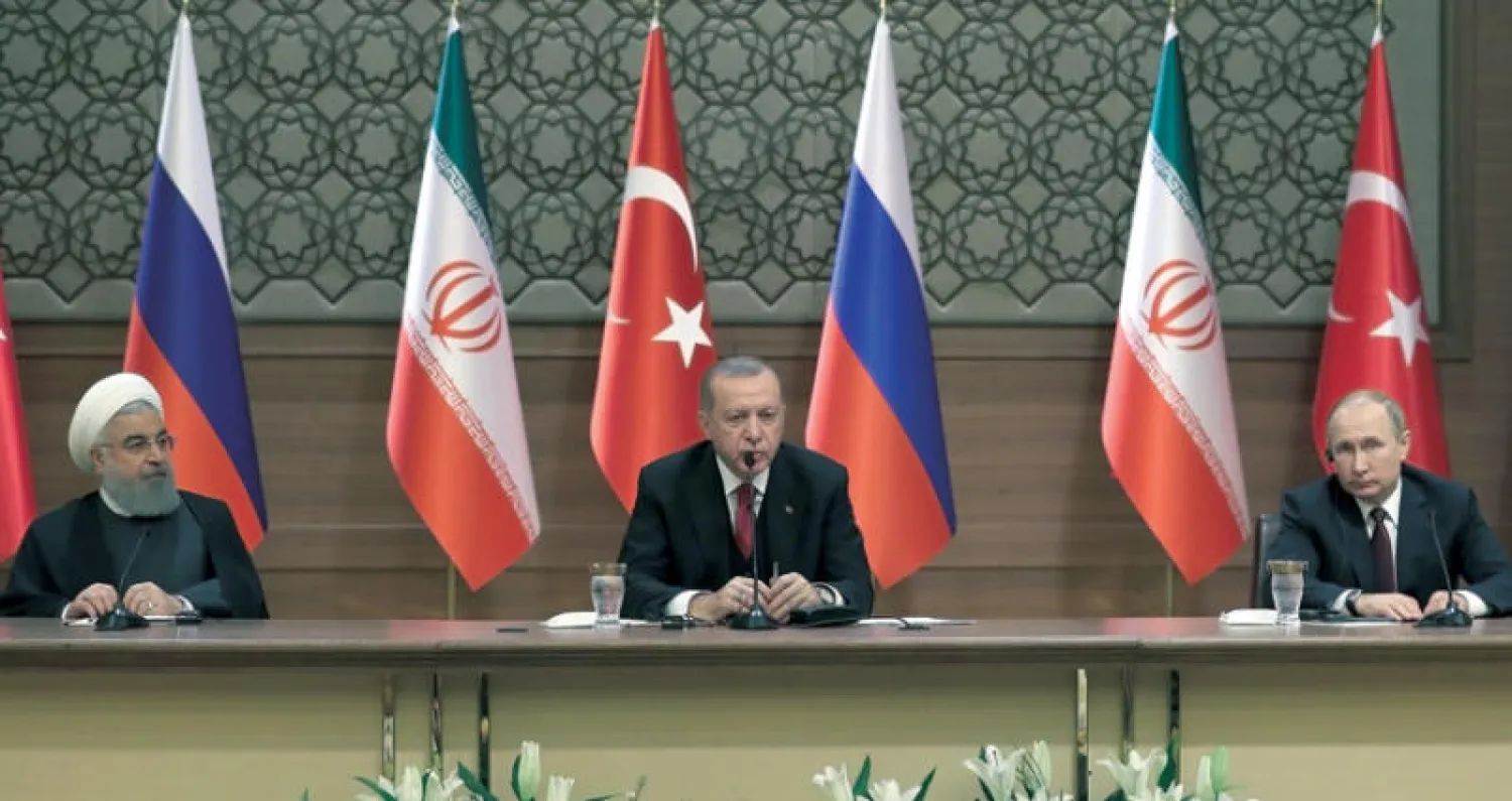 بوتين وإردوغان وروحاني في ختام قمة أنقرة أمس (أ.ف.ب)