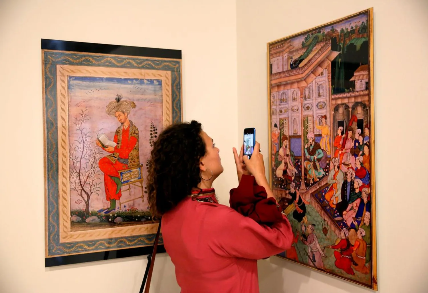 Woman takes photo at art exhibition at Babur Garden in Kabul, Afghanistan March 31, 2018. Picture taken March 31, 2018. REUTERS/Mohammad Ismail