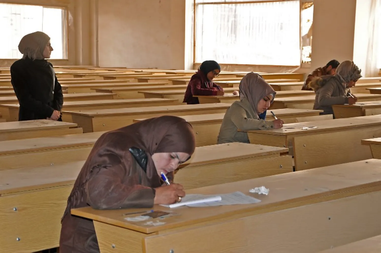 Syrian women write in a classroom at the Euphrates University in the city of Deir Ezzor on February 5, 2018. Ayham al-Mohammad / AFP