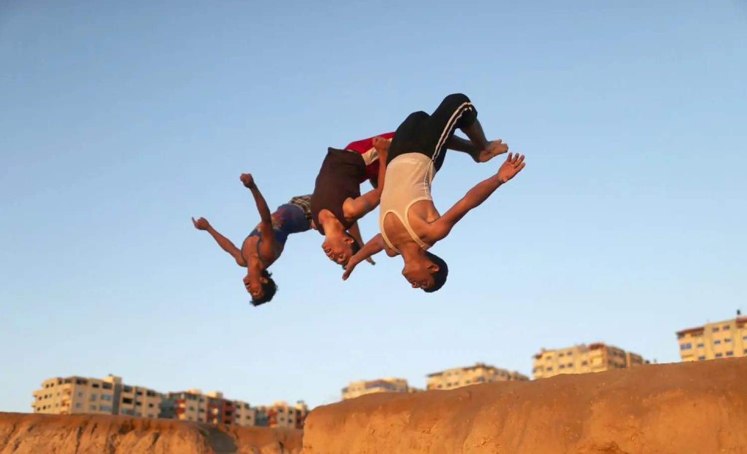 Palestinian youths practice their parkour skills at the Shati refugee camp in Gaza City. (Reuters)