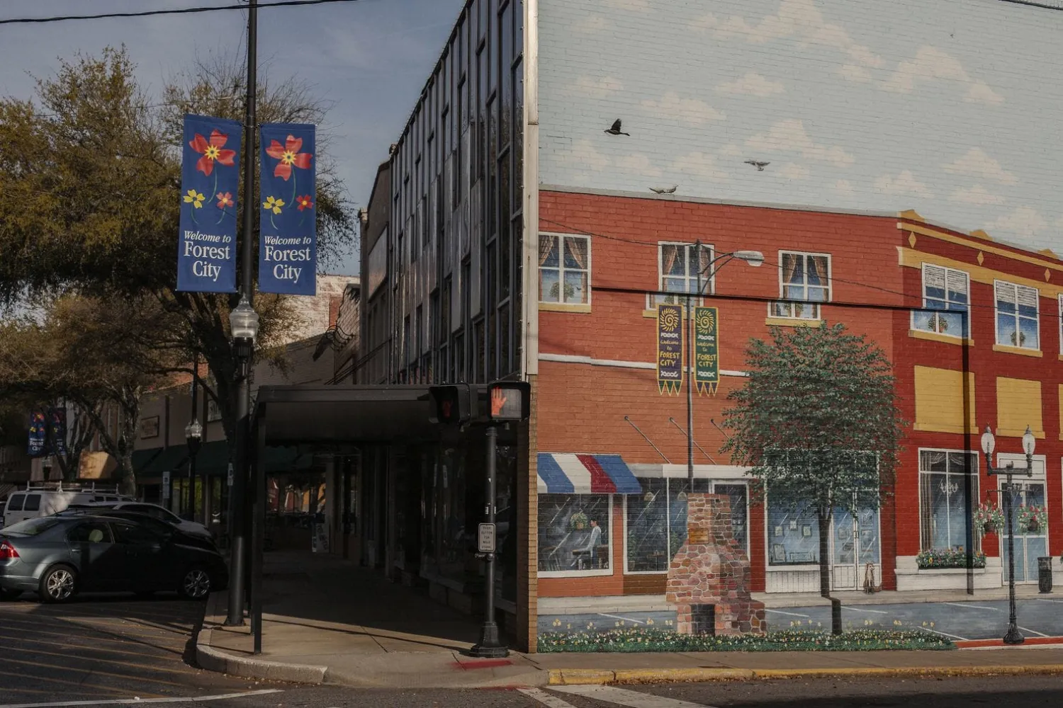 Signs and a mural welcome visitors to downtown Forest City. (Jacob Biba/For The Washington Post)
