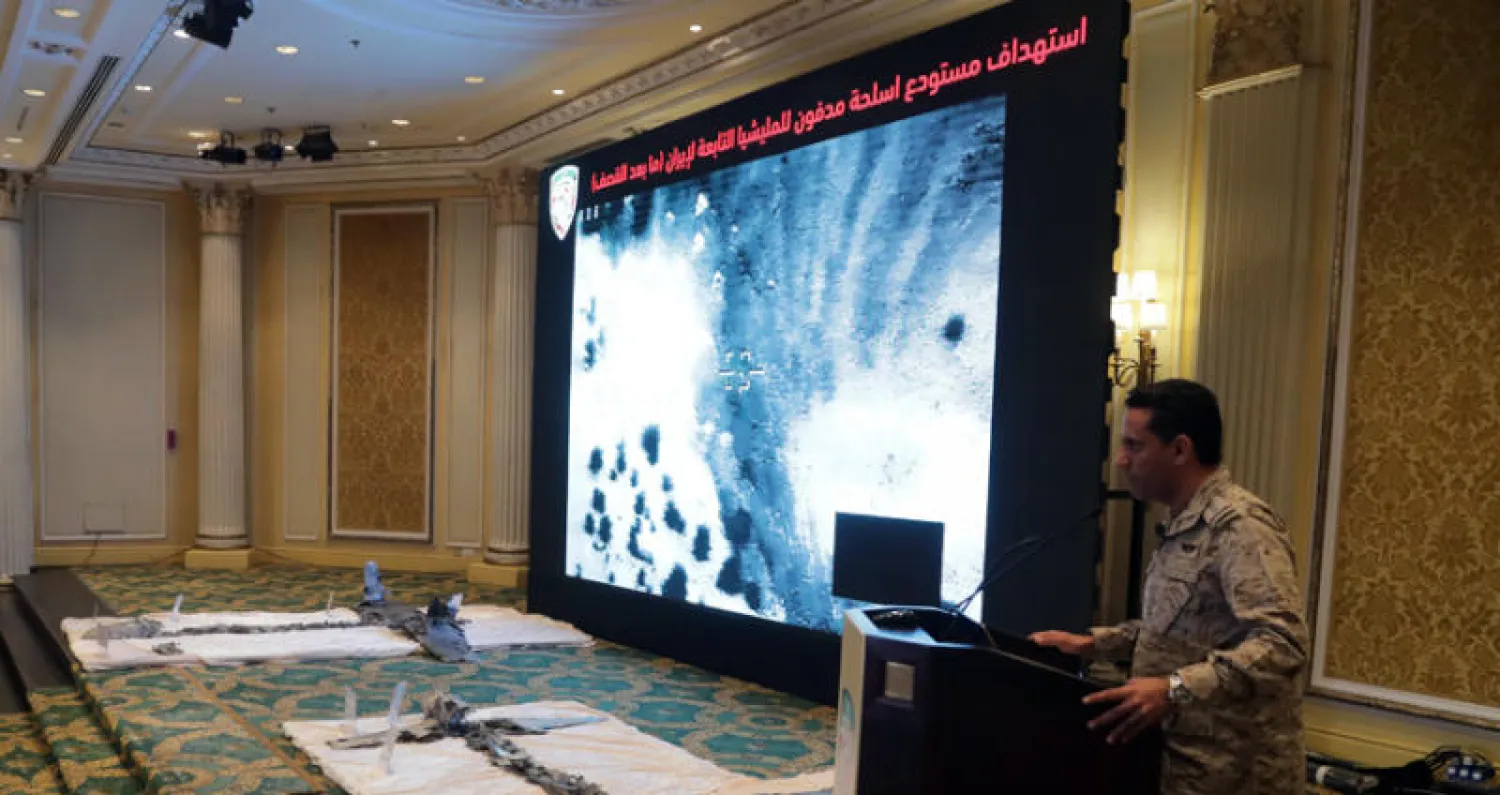 العقيد المالكي وإلى جانبه أجزاء من طائرتي «درون» استخدمهما الحوثيون في ضرب مدن سعودية وتم إسقاطهما (تصوير: عيسي الدبيسي)