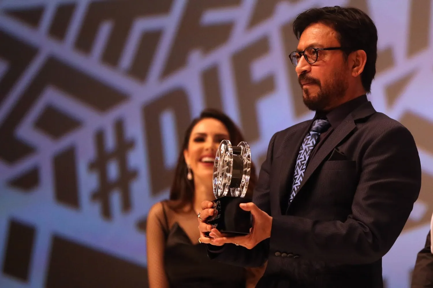 Indian actor Irrfan Khan is presented with an Honorary Award during the 14th Dubai International Film Festival on December 6, 2017. (AFP)