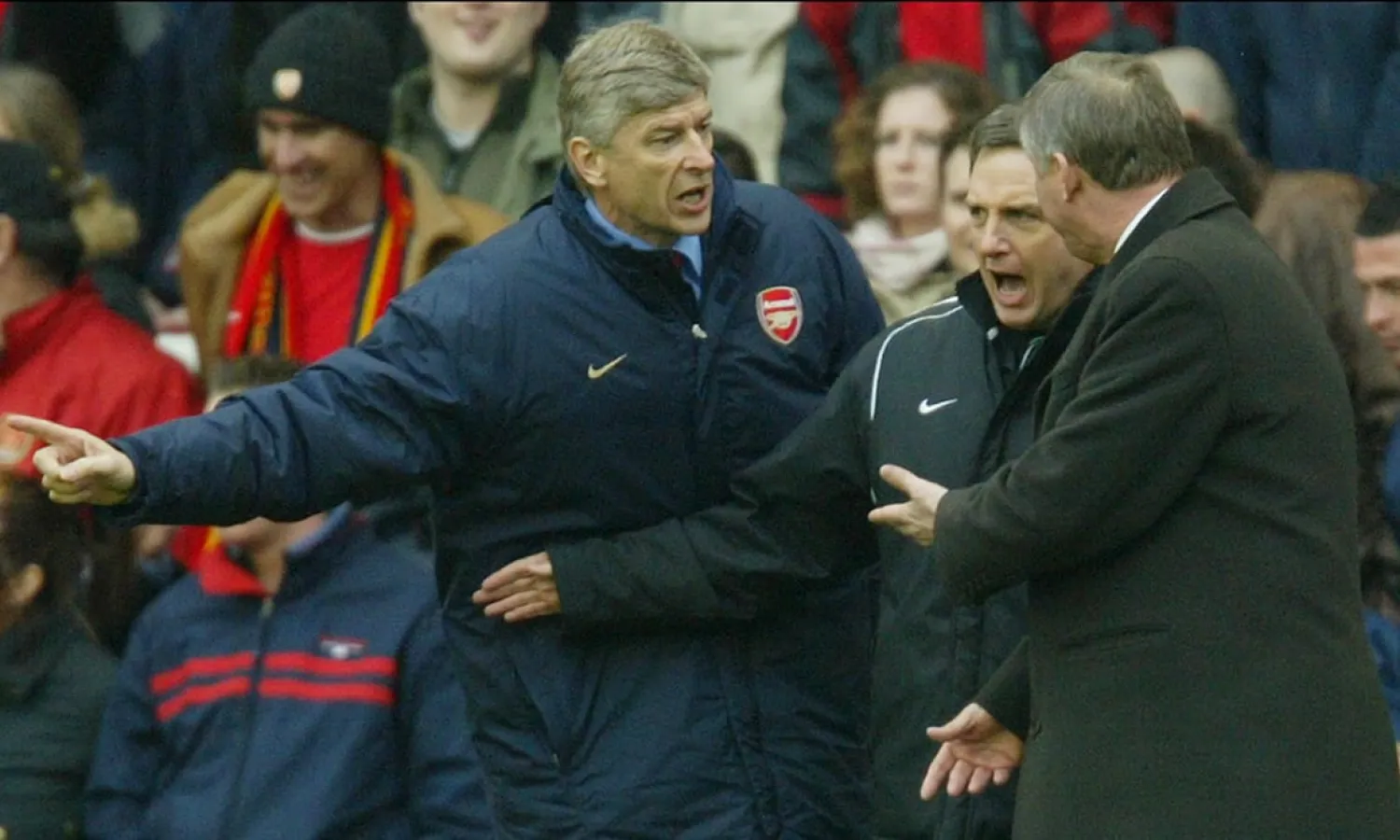  Arsène Wenger and Sir Alex Ferguson have to be separated by fourth official Alan Wiley during an Arsenal and Manchester United match at Highbury in March 2004. Photograph: Tom Jenkins for the Guardian
