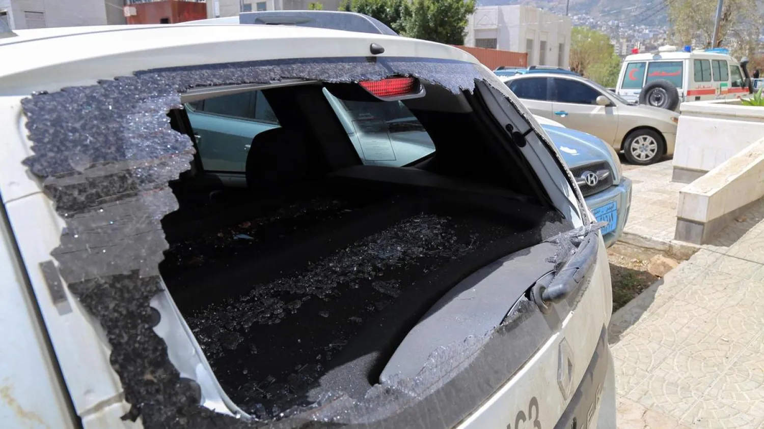 The shattered rear window of the Red Cross vehicle that was carrying Red Cross employee Hanna Lahoud, parked outside a hospital in the country's third-city of Taiz. Ahmad Al Basha / AFP