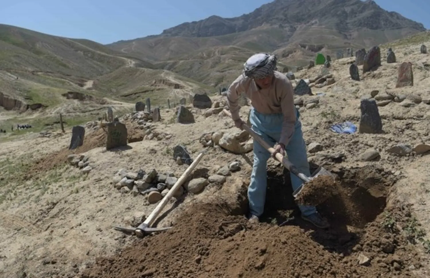 An Afghan man digs a grave for one of the 57 victims of a bomb blast before the burial a day after the attack on a voter registration centre in Kabul. (Shah Marai, AFP)
