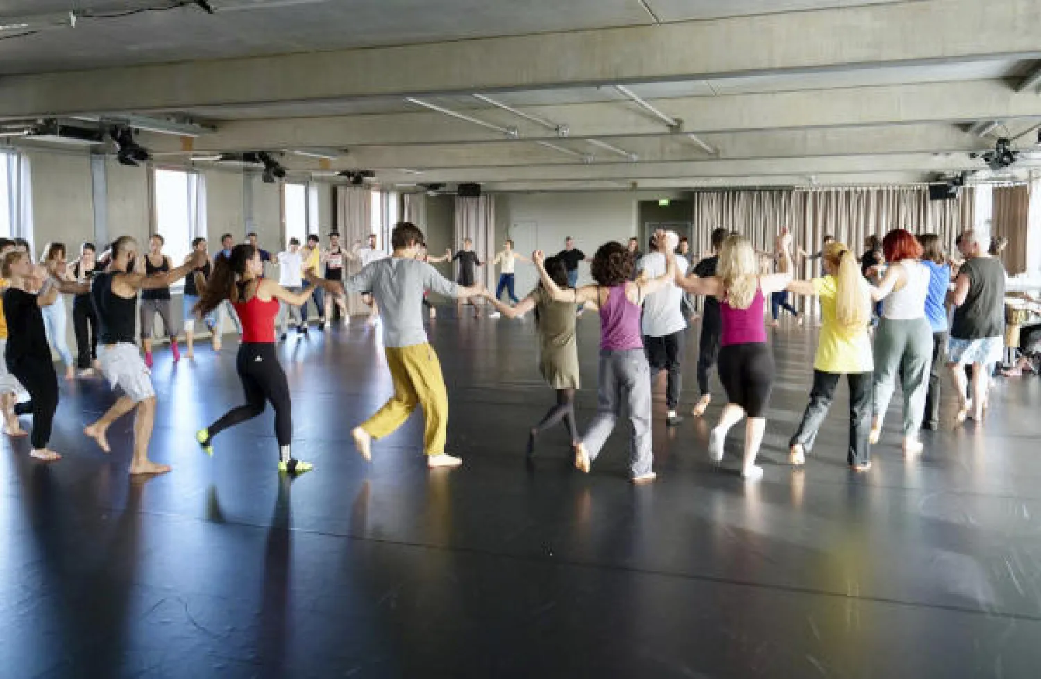 A group of people take a part in a workshop, led by Syrian migrants, to learn the traditional Arabic dance Dabke in Berlin, Germany. (AP)