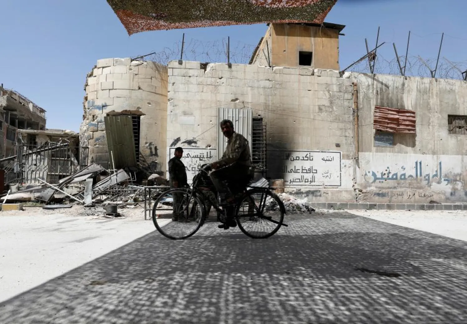 A man rides on a bicycle at the city of Douma in Damascus, Syria, April 20, 2018. (Reuters)