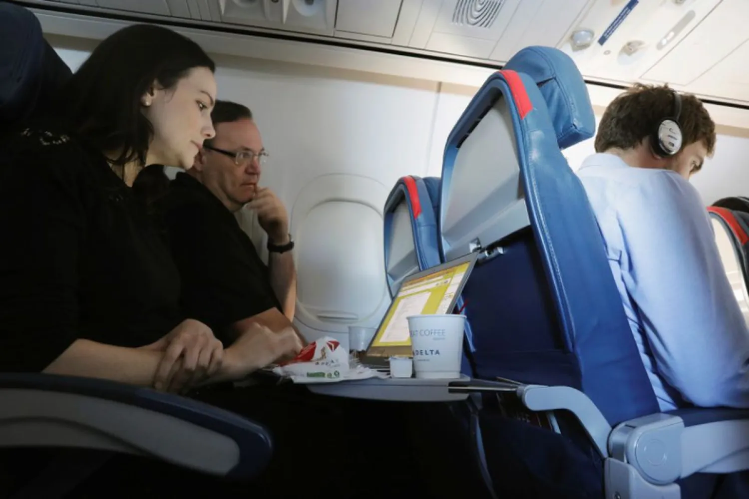 A woman uses her laptop on a flight out of John F. Kennedy (JFK) International Airport in New York, US, May 26, 2017. Picture taken May 26, 2017. REUTERS/Lucas Jackson
