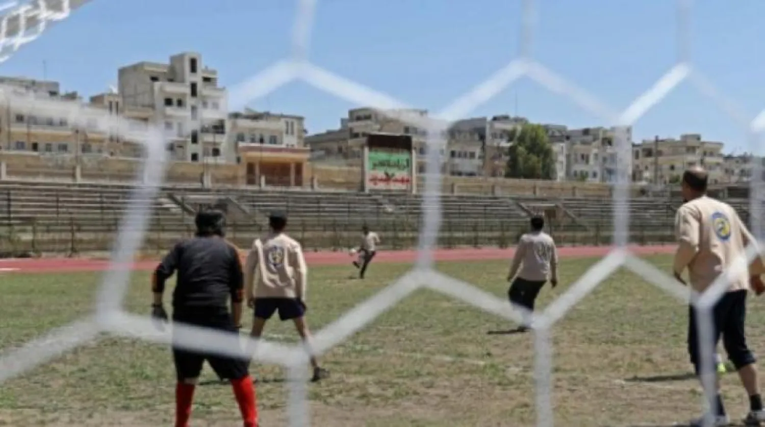A player kicks the ball during the first football game at Idlib's stadium since three years, in Idlib on April 25, 2018. OMAR HAJ KADOUR / AFP