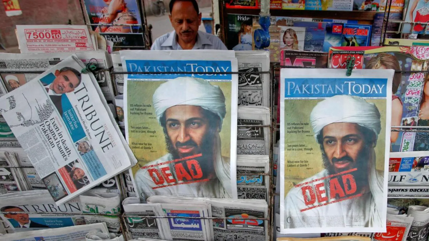 A roadside vendor sells newspapers with headlines about the death of Al-Qaeda leader Osama bin Laden, in Lahore May 3, 2011. (Reuters)