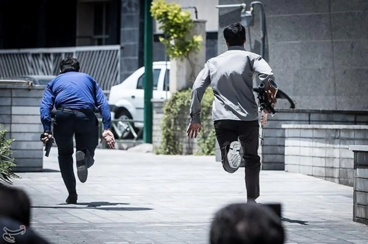 Members of Iranian forces run during an attack on the Iranian parliament in central Tehran, Iran, June 7, 2017. Tasnim News Agency/Handout via REUTERS