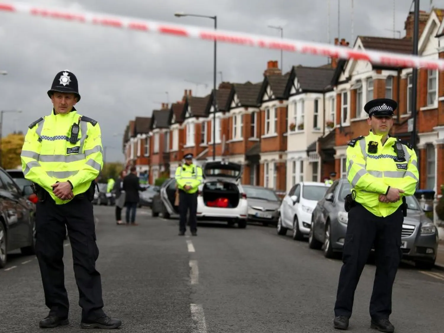 Police officers stand next to terraced housing in Harlesden Road, north London. Reuters file photo
