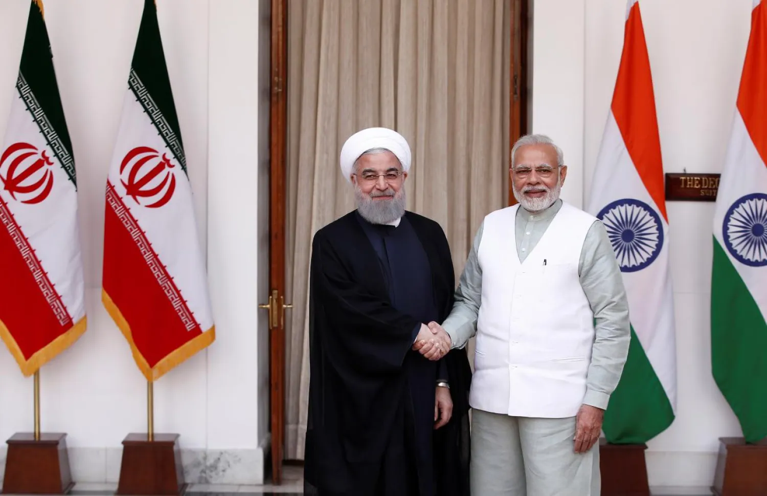 Iranian President Hassan Rouhani shakes hands with India's Prime Minister Narendra Modi (R) during a photo opportunity ahead of their meeting at Hyderabad House in New Delhi, India, February 17, 2018. REUTERS/Adnan Abidi