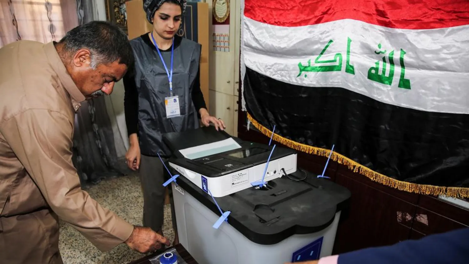 An Iraqi voter dips his finger in ink before casting his ballot at a poll station in the capital Baghdad's Karrada district on May 12, 2018. (AFP)
