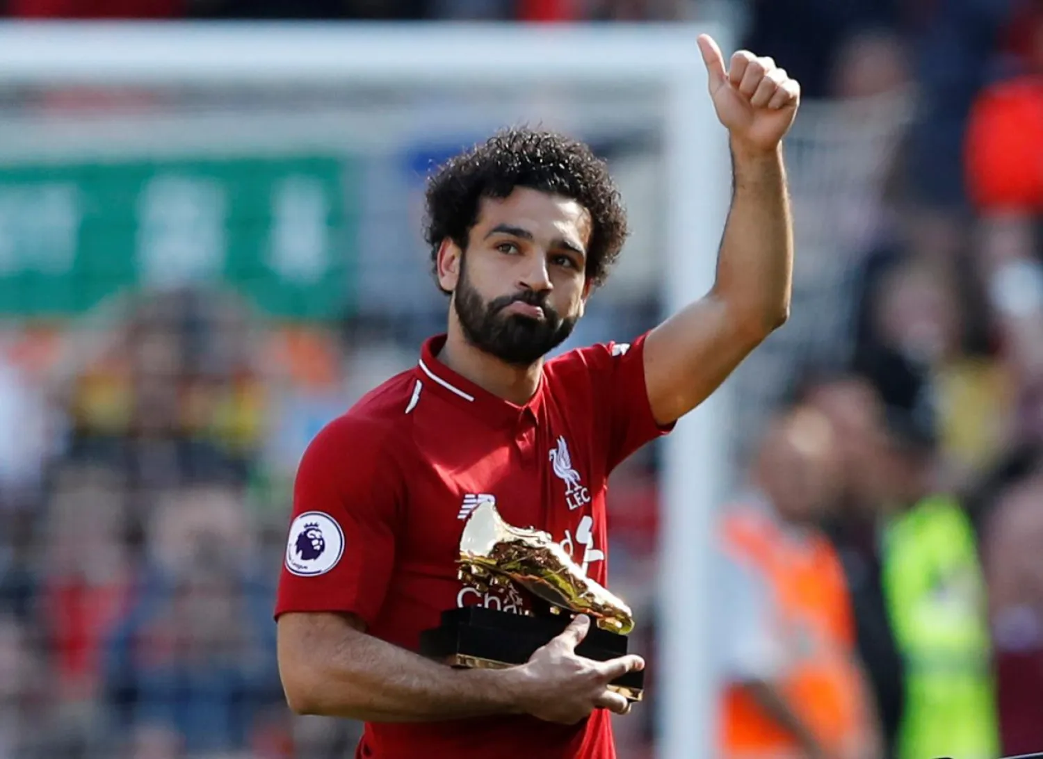Liverpool's Mohamed Salah celebrates with the Golden Boot after a match against Brighton & Hove Albion on May 13. (Reuters)