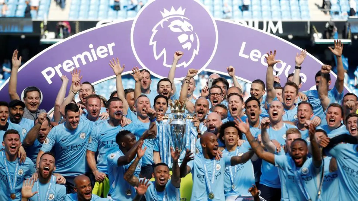 Manchester City players lift the Premier League trophy at the Etihad Stadium. (Reuters)
