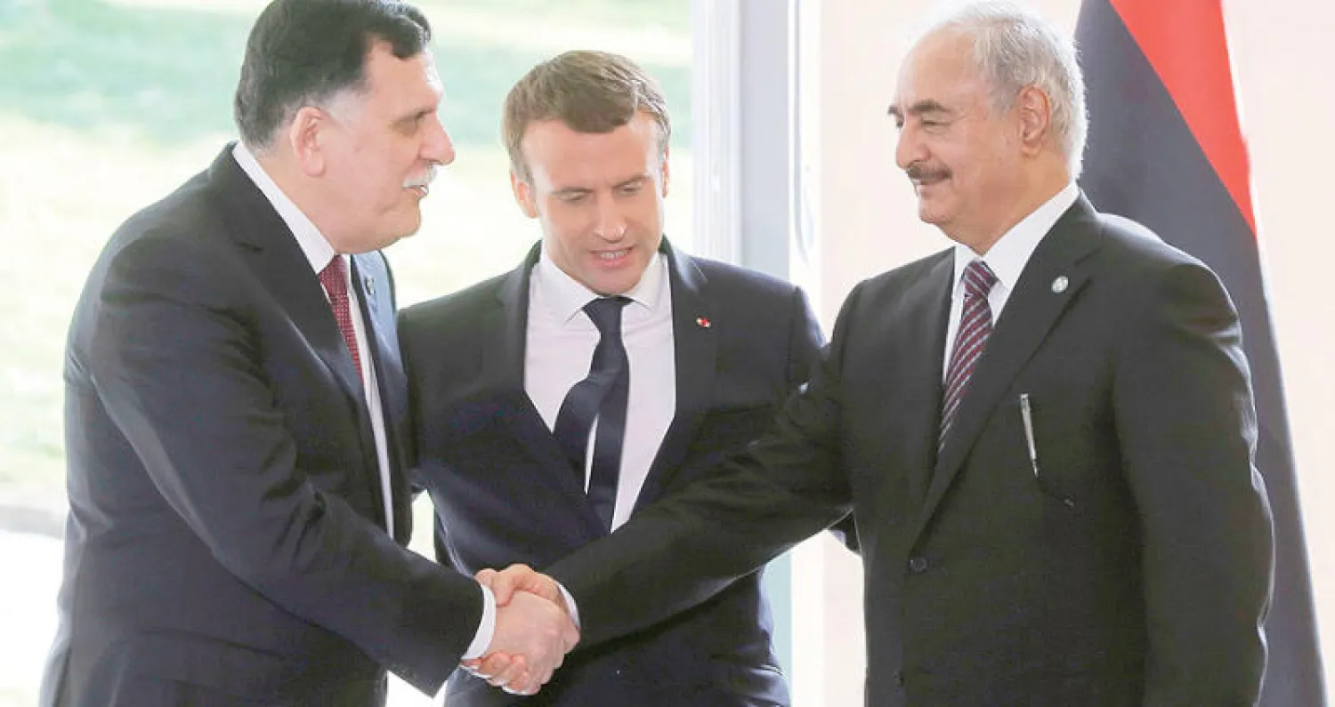 حفتر يصافح السراج خلال لقاء في باريس برعاية الرئيس الفرنسي إيمانويل ماكرون في يوليو الماضي (غيتي)