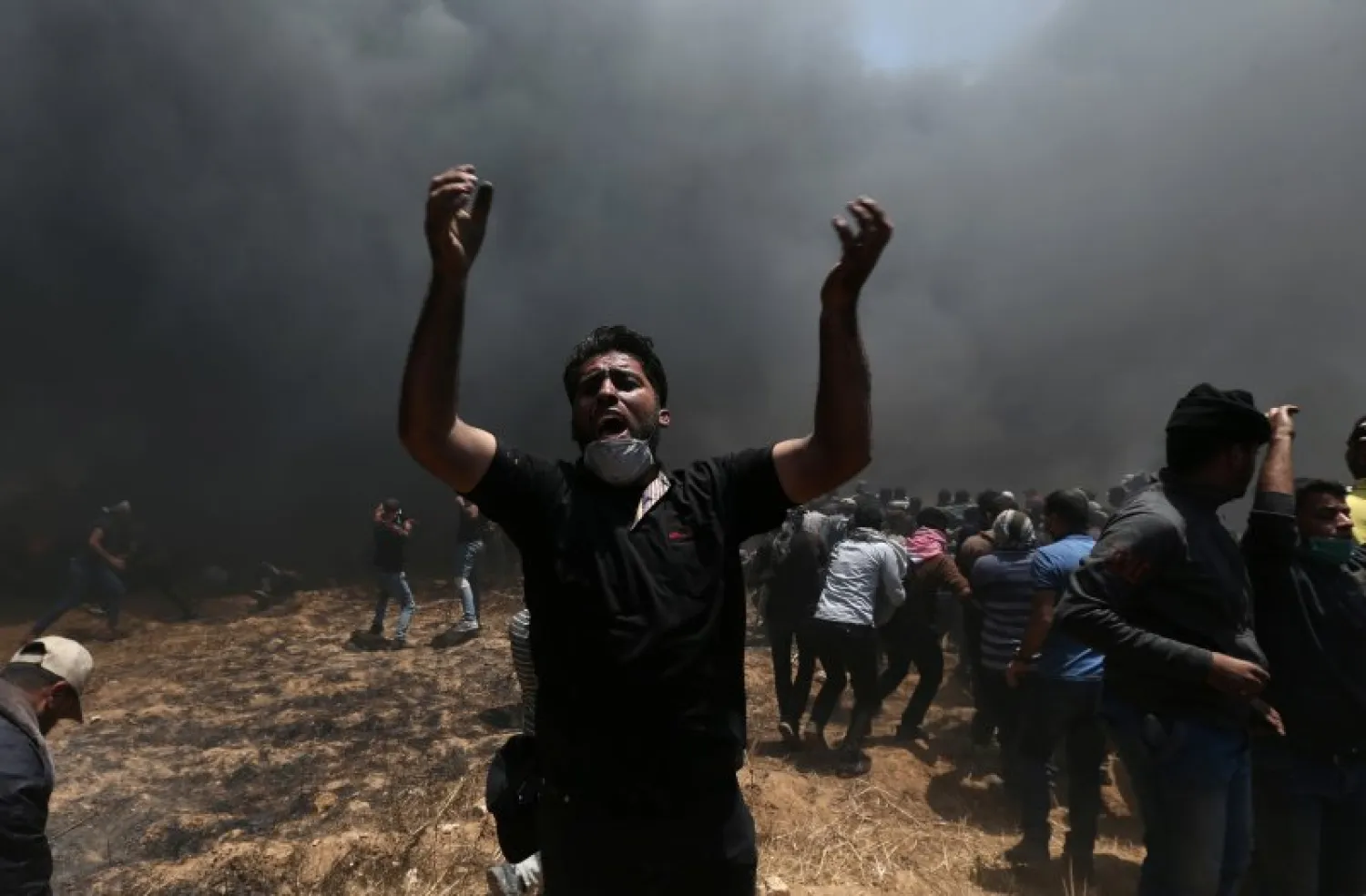 A Palestinian demonstrator shouts during a protest against the US embassy move to Jerusalem and ahead of the 70th anniversary of Nakba, at the Israel-Gaza border in the southern Gaza Strip. REUTERS/Ibraheem Abu Mustafa