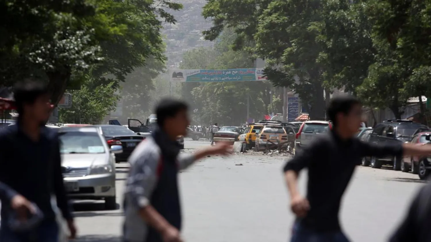 Afghans run from the site of an attack in Afghanistan. (AP)