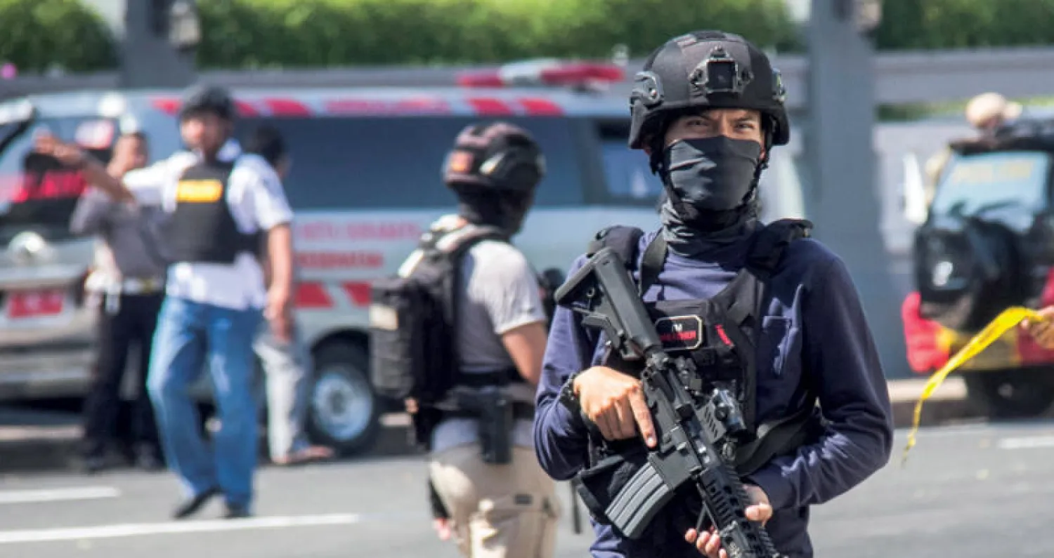 ضباط أمام مركز شرطة في مدينة سورابايا ثاني أكبر مدن إندونيسيا (إ.ب.أ)