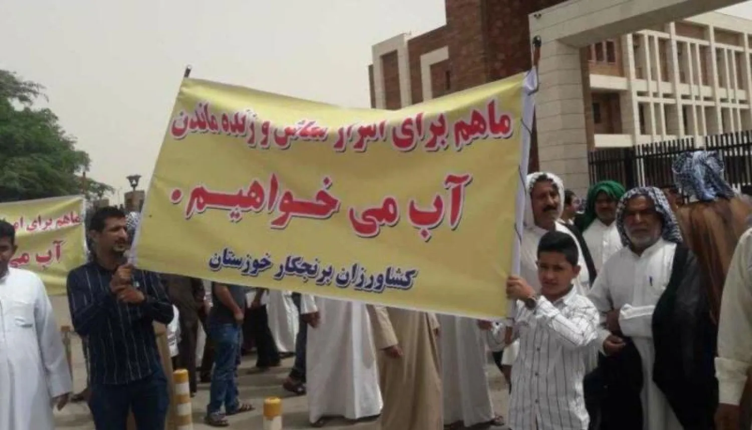 مزارعون أحواز يرفعون لافتة كتب عليها «نحن نريد المياه من أجل عيشنا والبقاء على قيد الحياة» («الشرق الأوسط»)