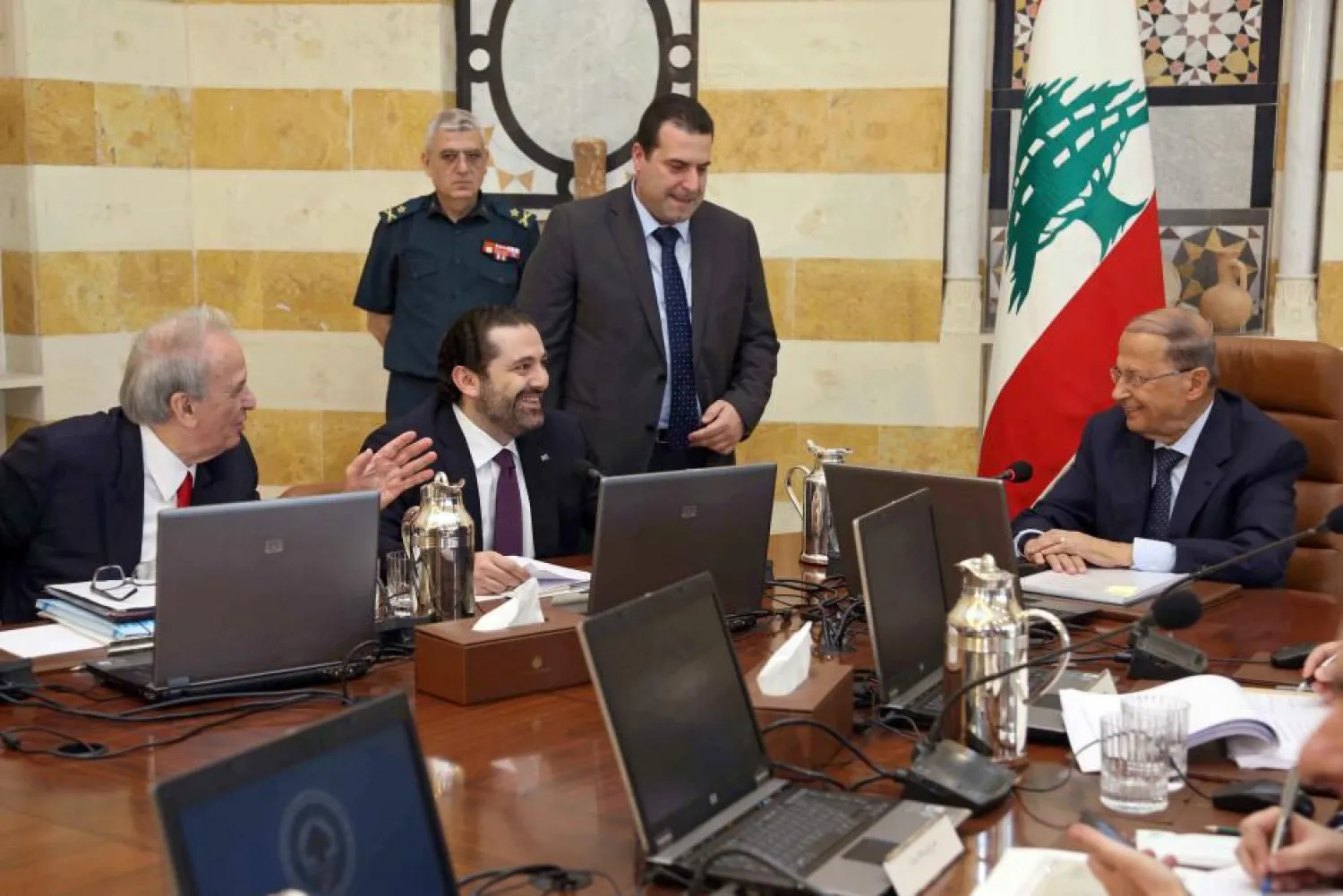 Lebanese President Michel Aoun chats with PM Saad Hariri as Education Minister Marwan Hamadeh looks on during a cabinet meeting. (Reuters)
